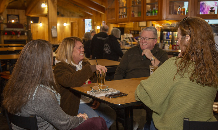Guests gathering at a table inside Campton Mountain lodge
